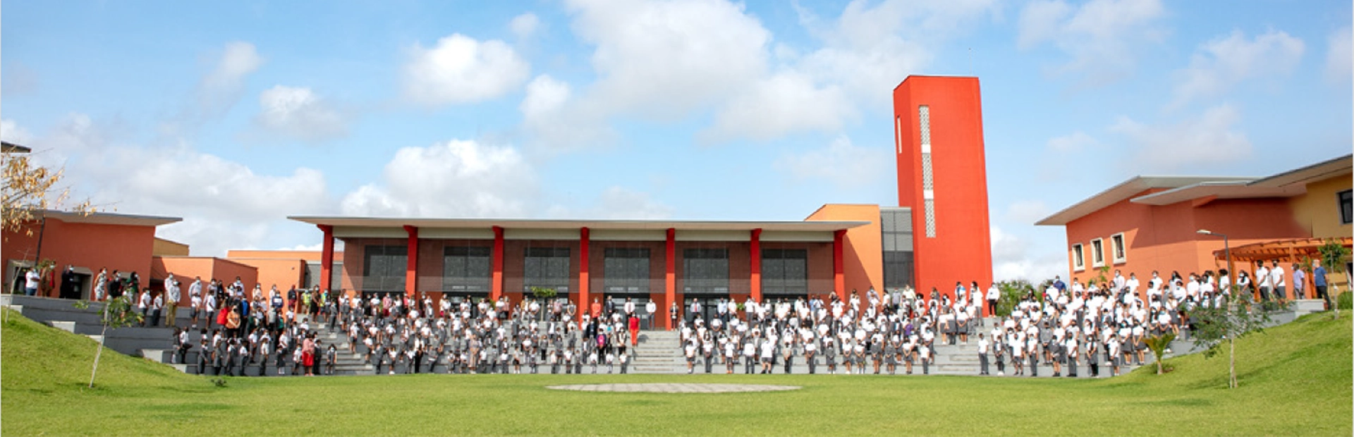 Students jumping up in the air on a beach.